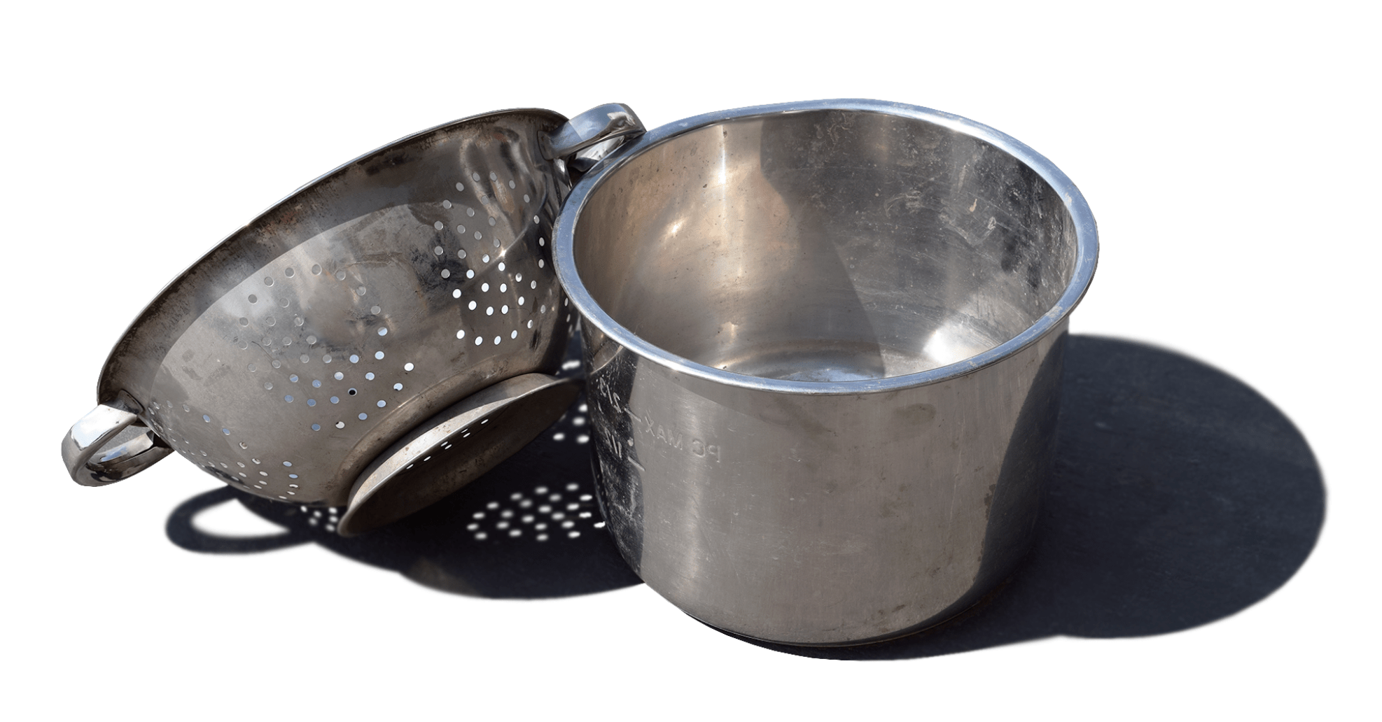 A stainless steel colander and pot, perfect for straining and cooking.